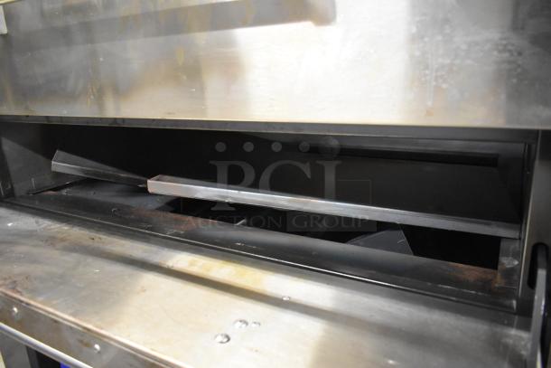 Peerless stainless steel commercial 2-deck pizza oven on metal legs, showing interior and robust build, good condition.