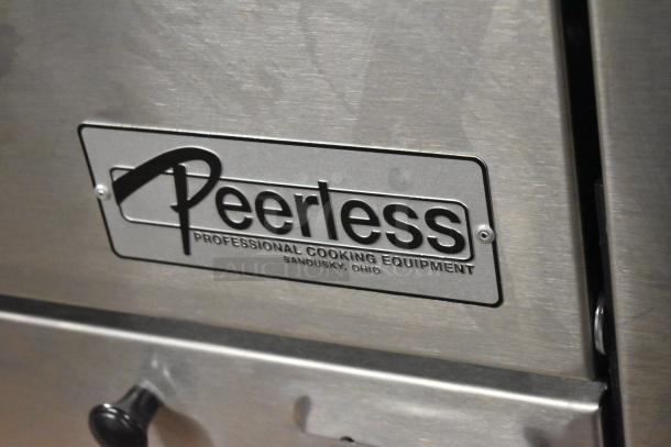 Peerless stainless steel commercial 2-deck pizza oven on metal legs, features professional cooking equipment label from Sandusky, Ohio.