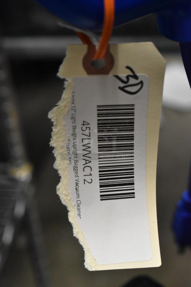 Lavex 457LWVAC12 12" upright vacuum cleaner tag, showing brand and model details. Includes barcode and handwritten "SD".