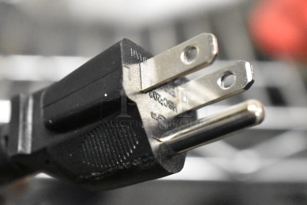 Close-up of a power plug for the 2021 AvaMix 928BX1100P commercial blender, showing prongs and partial markings.