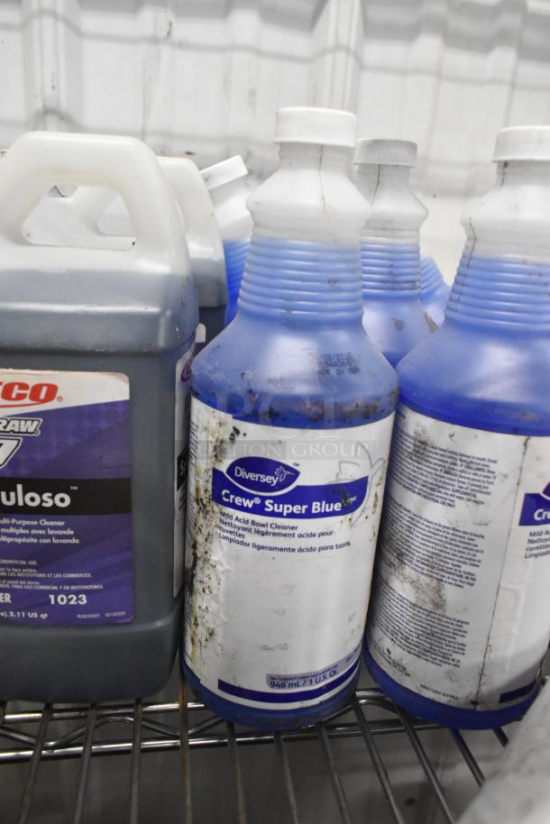 Tier lot of cleaning supplies including Betco Spectaculoso multi-purpose cleaner and Diversey Crew Super Blue. Used condition.