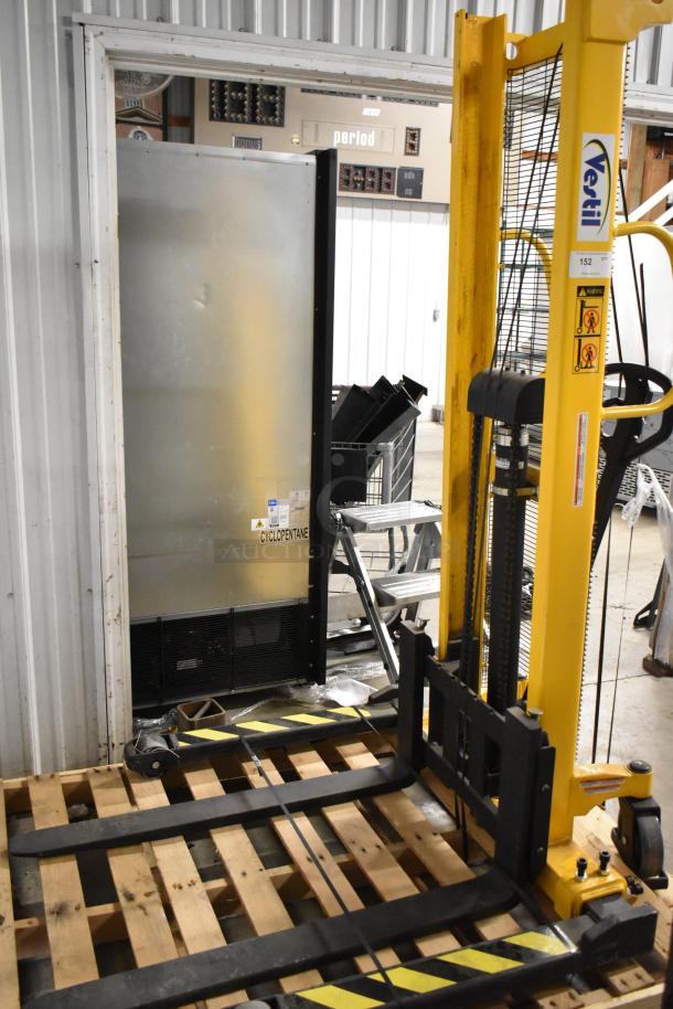 Brand new Vestil VHPS-2000-AA metal manual stacker with 2,000 lb capacity, adjustable legs and forks, minor scratches.