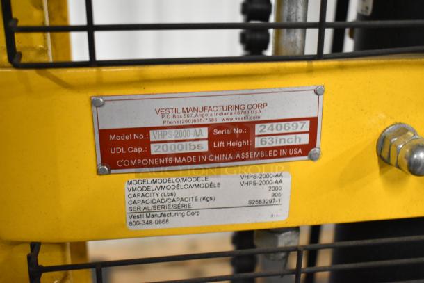 BRAND NEW Vestil VHPS-2000-AA Manual Stacker, 2,000 lbs capacity, adjustable legs/forks, scratch and dent; Model, UDL, and lift height tags visible.