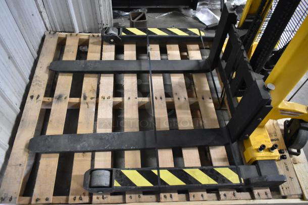 Brand new Vestil VHPS-2000-AA metal stacker, 2,000 lb capacity, manual, adjustable legs/forks, minor scratches, on wooden pallet.