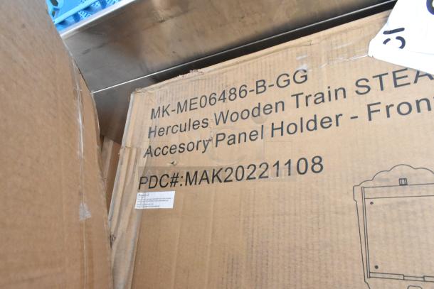 Cardboard box labeled "MK-ME06486-B-GG Hercules Wooden Train STEAM Accessory Panel Holder" with PDC# MAK20221108.