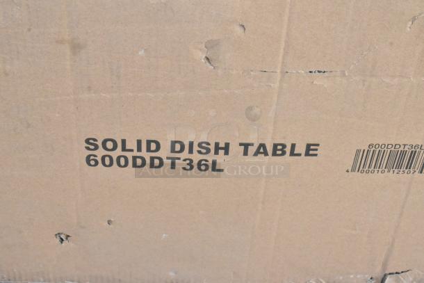 Cardboard box labeled "SOLID DISH TABLE 600DDT36L" with visible barcode, indicating a Regency 3' dish table. Box shows minor wear.