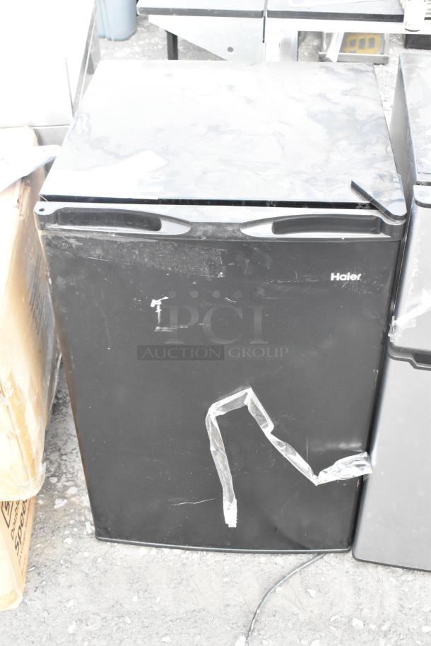 Haier HC46SF10SB mini cooler, black, visible wear, scuffed exterior. 115 volts, 1 phase, auction item.