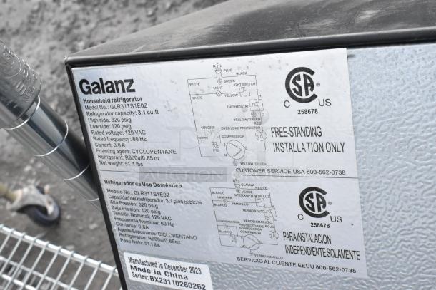 Galanz GLR31TS1E02 mini cooler label, 3.1 cu.ft capacity, 120 VAC, 60 Hz, R600a refrigerant, manufactured in December 2023.