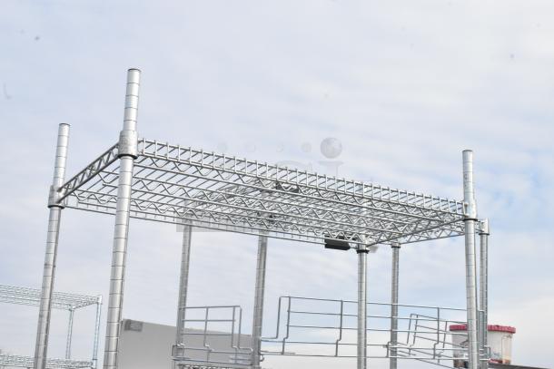 Two metal wire shelving units, durable construction, new condition. Buyer responsible for dismantling and freight charges.