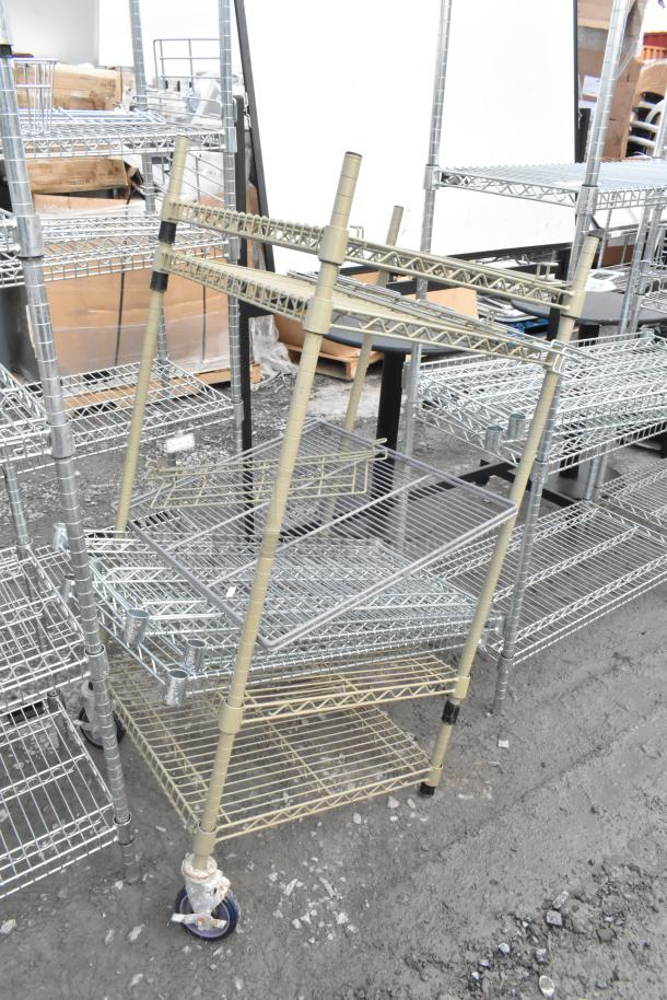 Two wire shelving units with multiple levels, mixed metal finish, some with wheels. Condition appears used. Buyer must dismantle.