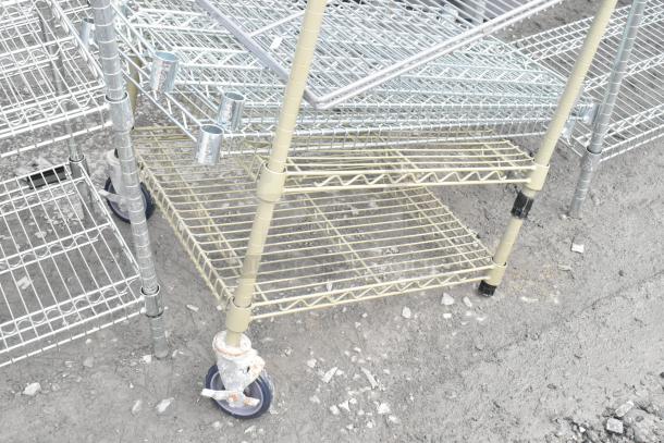 Two wire shelving units on wheels, various colors, used condition. Buyer to dismantle. Consider freight costs.