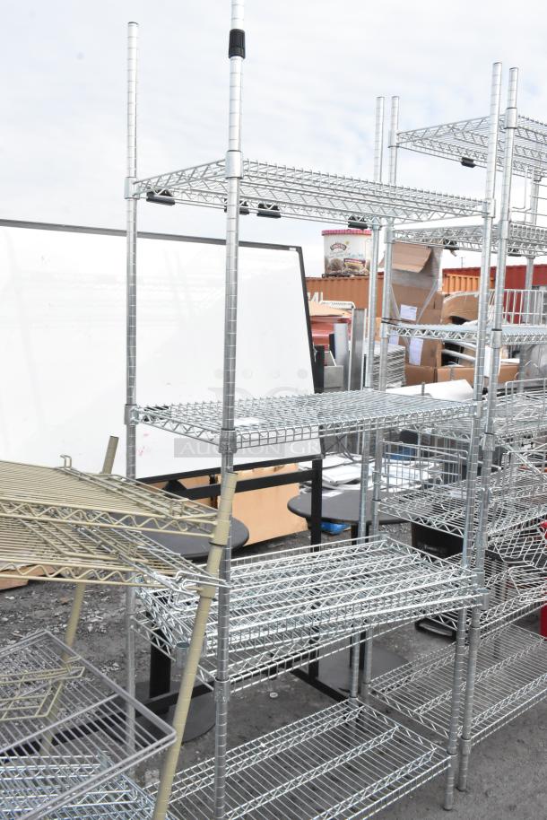 Two chrome finish wire shelving units outdoors, sturdy design, with multiple adjustable shelves. Buyer must dismantle for shipping.