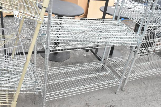 Two chrome finish wire shelving units in good condition, featuring multiple tiers. Buyer must dismantle. Freight charges apply.