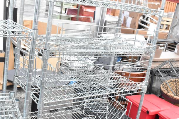 Two chrome finish wire shelving units, undismantled, stacked together. Buyer must dismantle for shipping.
