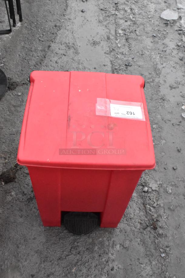 Two red poly foot pedal trash cans, containing a fire extinguisher and a fan. Pickup only, no shipping for extinguisher.