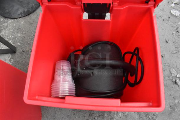 2 red poly foot pedal trash cans with contents including a fan and fire extinguisher; items in good condition. Buyer pickup required.