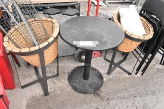 Round black table and two wicker basket stands with black metal frames. Table labeled "163". Slight wear visible.