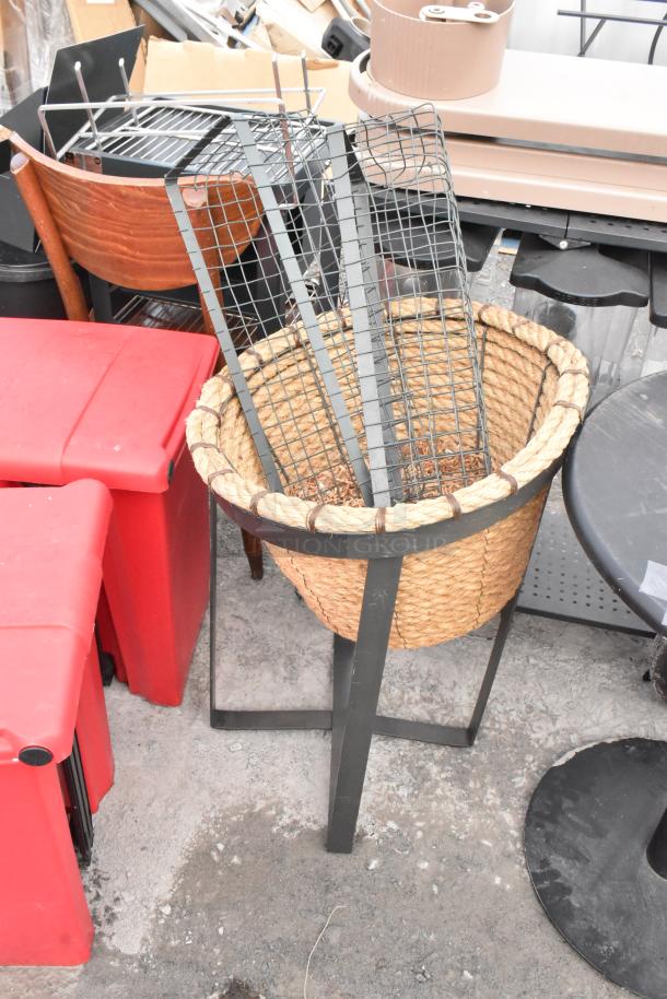 Round table and 2 basket stands with metal frames. Table has a black base; baskets feature rope design. Mixed condition.