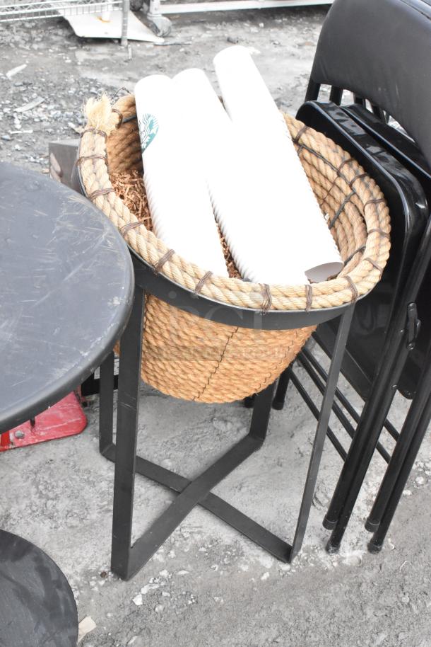 Round table and two basket stands with metal frames and woven rope texture; used condition. Auction for three items.