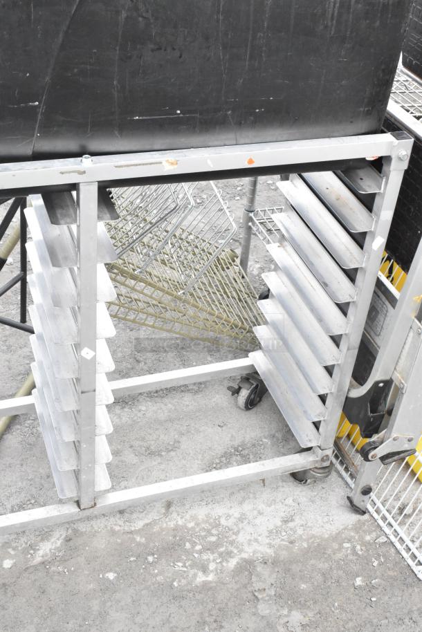 Metal commercial double pan transport rack with casters, includes contents of 2 black trash cans, good condition.