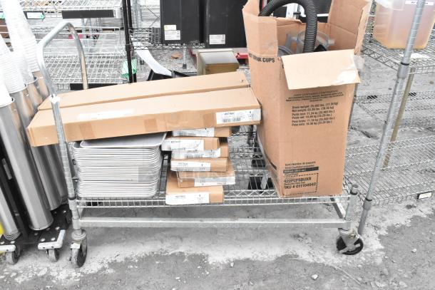 Chrome finish shelving unit with metal baking pans and WST969C divider kits, buyer must dismantle.