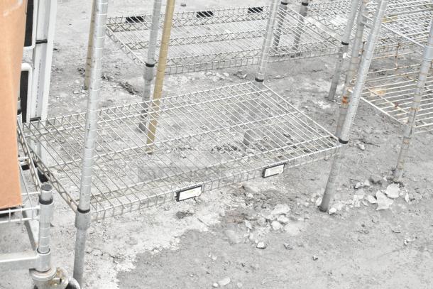 Chrome finish 4-tier shelving unit, off-site. Buyer must dismantle. Consider freight charges. Durable wire construction.