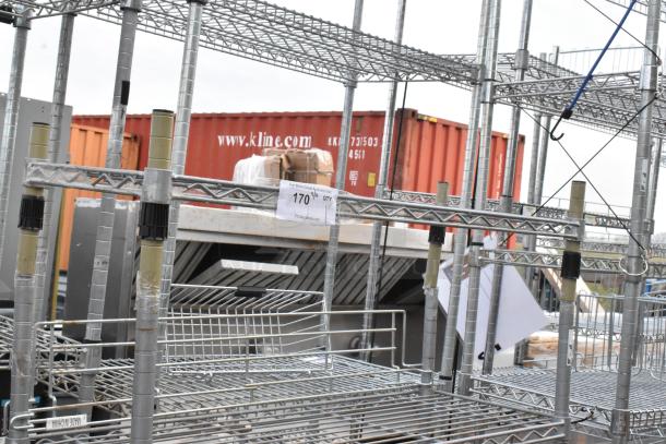 Chrome finish 5-tier shelving unit, sturdy metal construction, visible label indicating buyer dismantling required.