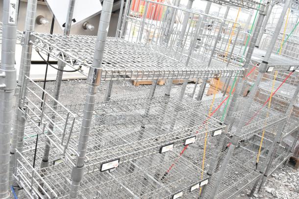 Chrome finish 7-tier shelving unit with wire shelves, in good condition. Buyer must dismantle for shipping. Freight charges apply.