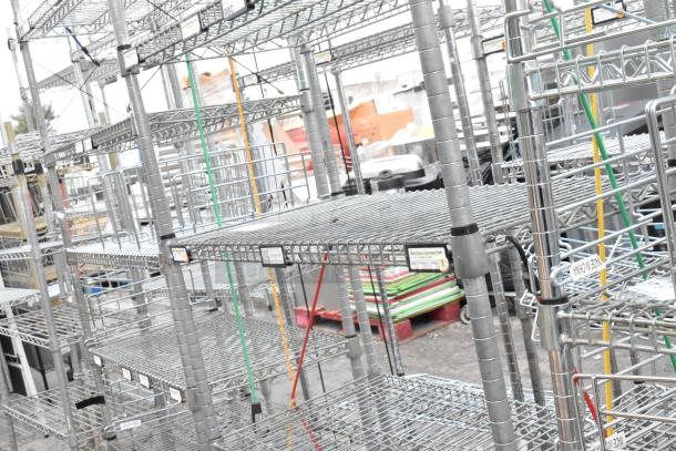 Chrome finish 5 tier shelving unit, metal, sturdy construction, requires dismantling by buyer, tags indicate item categories.