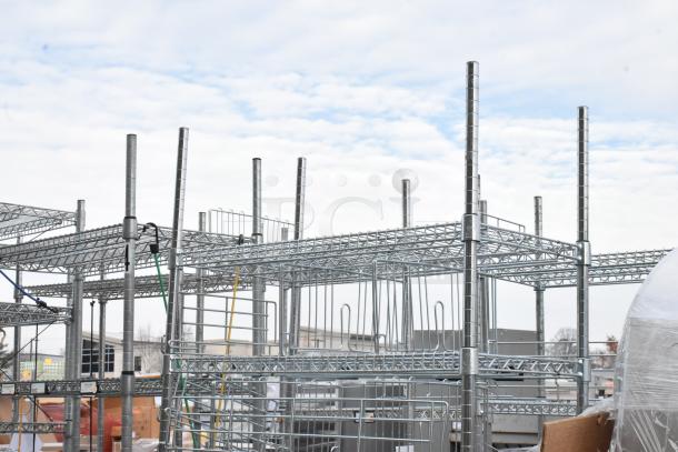 Chrome finish 6-tier shelving unit, industrial design. Buyer must dismantle. Consider freight charges.