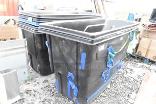 Brand new black poly tilt trucks with scratch and dent condition, features blue protective tape. Auction for 7 units.