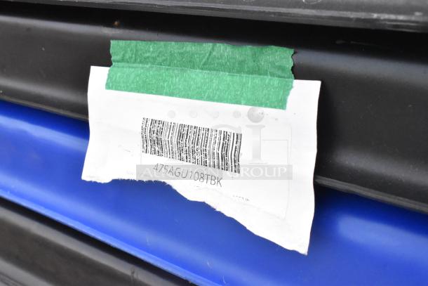 Close-up of black poly tilt truck showing barcode label with number "475AGU108TBK." New, scratch and dent condition.