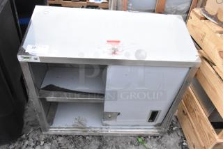 BRAND NEW SCRATCH AND DENT Regency 600WCS1536 36" stainless steel wall cabinet with one sliding door missing.
