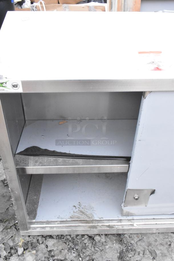 Regency 600WCS1536 stainless steel wall cabinet with sliding doors, new condition, missing one door, NSF certified.