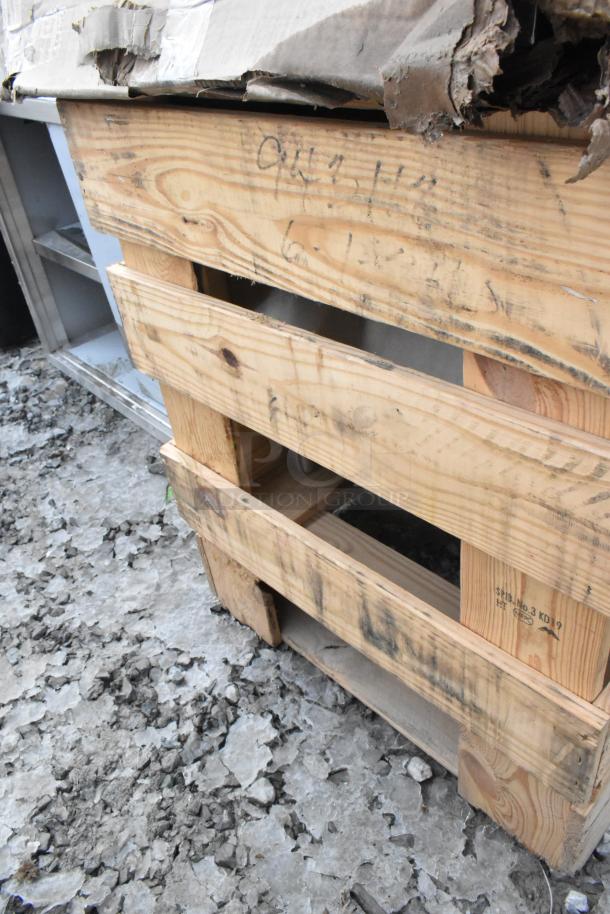 Two new scratch and dent Regency 16-gauge stainless steel mop sinks with notched front, 24" x 24" x 12", on pallet.