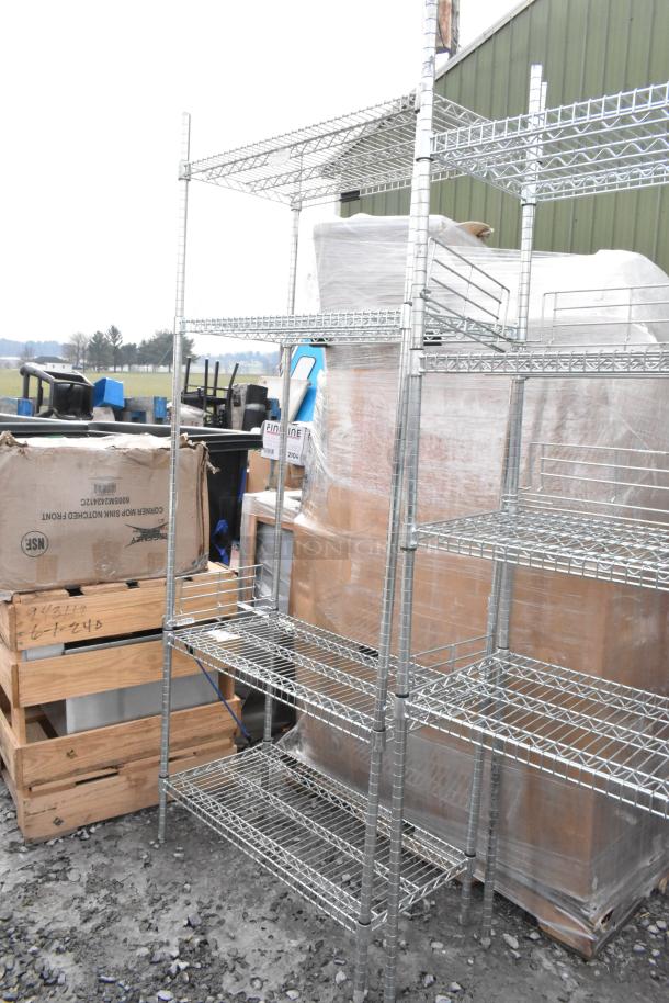 Two chrome finish wire shelving units, sturdy metal construction, multiple shelves, dismantle required, freight charges apply.