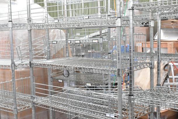 Two chrome finish wire shelving units, sturdy construction, multiple shelves, ideal for storage. Buyer dismantles for shipping.