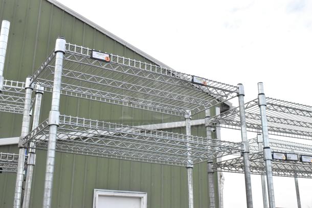 Two chrome finish wire shelving units in excellent condition, multi-tier design, with visible condition labels. Buyer dismantles.