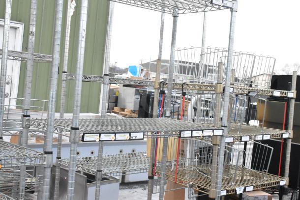 Two chrome finish wire shelving units in good condition, with multiple adjustable shelves. Dismantling required for removal.