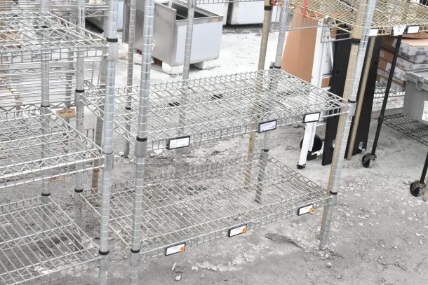 Two chrome finish wire shelving units, 3-tier each, excellent condition, with assembly labels visible. Buyer must dismantle.