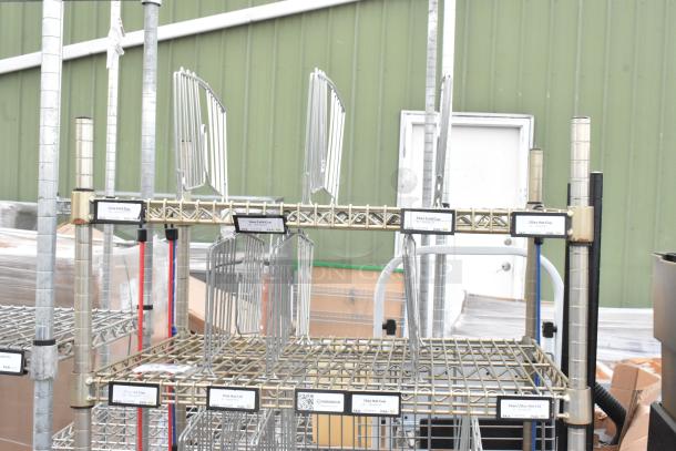 3 Tier wire shelving unit with labeled racks. Buyer must dismantle. Tags indicate sizes for cold and hot cups. Freight charges apply.