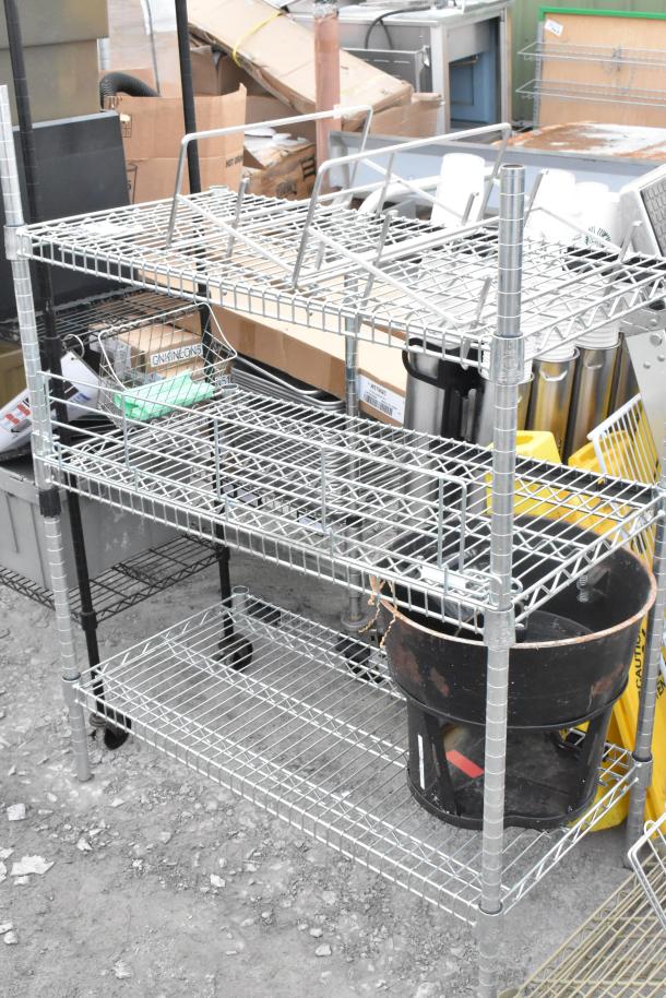 Two metal wire shelving units, one missing three poles. Buyer dismantles. Consider freight charges.