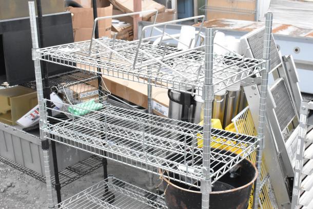 Two wire shelving units, silver, one missing three poles, fully assembled, used condition, buyer to dismantle.
