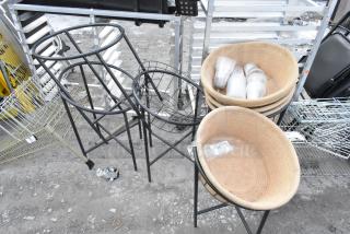 5 black metal basket stands with 4 woven baskets, some holding cups. Each basket is labeled "185 qt." Suitable for display.