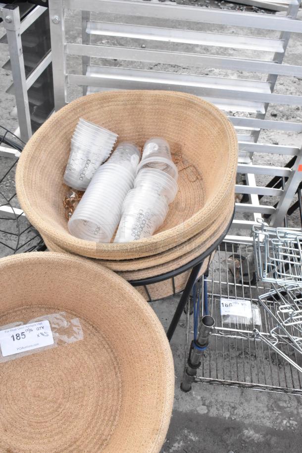 5 basket stands with 4 woven baskets, some containing plastic cups. Tag reads "185". Ideal for retail display.