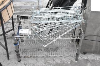 Chrome finish 2-tier wire shelving unit with contents. Buyer must dismantle. Label reads "186 QTY 1". Consider freight charges.