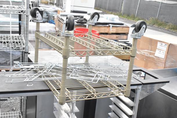 2-tier metal shelving unit and double pan transport rack with commercial casters; labeled "SSI."