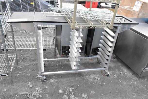 Two-tier shelving unit and metal commercial double pan transport rack on commercial casters, in used condition.