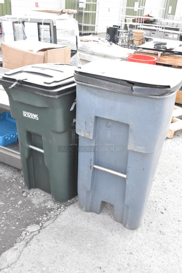 Two large poly trash cans, one green and one blue, in used condition. Visible marking: "U2826945" on the green can.
