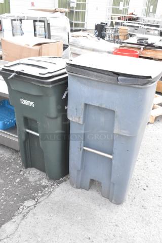Two large poly trash cans, one green and one blue, in used condition. Visible marking: "U2826945" on the green can.